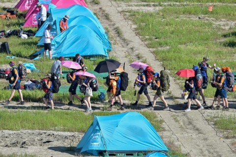 Scouts prepare to leave the  World Scout Jamboree camspite in South Korea's North Jeolla province, which has been plagued by problems and is being evacuated as a typhoon approaches