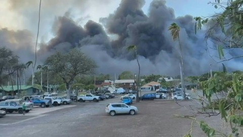 A thick cloud of smoke rises as a wildfire breaks out in the town of Lahaina, on the west coast of Hawaii's Maui Island