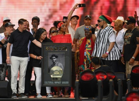 US rapper DJ Kool Herc (R) recieves the Cultural Impact Award during the Hip Hop 50 Live concert, which marked five decades of the genre