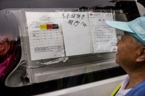 A colour-coded system for heat guidelines is displayed on the side of a van in Hong Kong