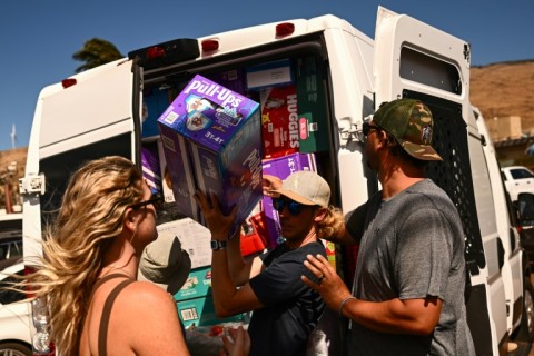 Pacific Whale Foundation volunteers unload a van of diapers as they load boats with supplies to deliver to Maui families affected by the wildfire 