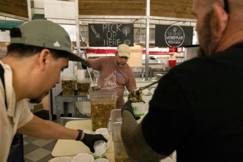 The team of chefs and dozens of volunteers prepares and packages about 9,000 meals every day