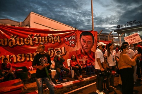 Supporters of former Thai PM Thaksin Shinawatra gather outside Bangkok's Don Mueang airport