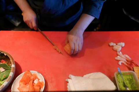 A chef cuts salmon at a Japanese restaurant in Beijing 