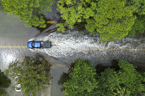 A truck drives along a flooded street in New Port Richey, Florida