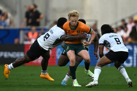 Australia fly-half Carter Gordon (centre) had a bruising encounter with Fiji