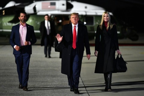 Then-US president Donald Trump is seen walking with his children Ivanka Trump (R) and Donald Trump Jr (L) on January 4, 2021