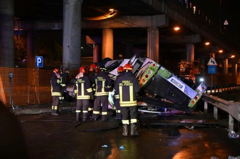 Firefighters said the bus caught fire after careering off a bridge straddling a railway line a