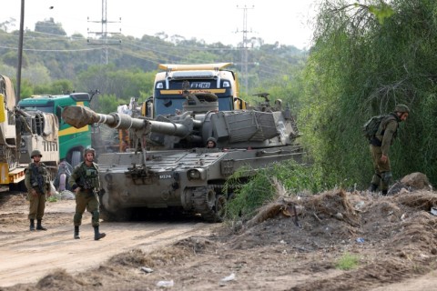 Israeli troops at an undisclosed location on the border with the Gaza Strip on October 8, 2023