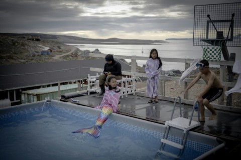 A young girl in a mermaid costume in the Inuit village of Ittoqqortoormiit, Greenland