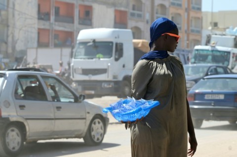 A street vendor sells plastic sachets filled with drinking water in Dakar