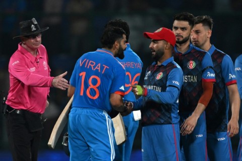 Respect: Afghanistan players greet India's Virat Kohli  at the end of the match 