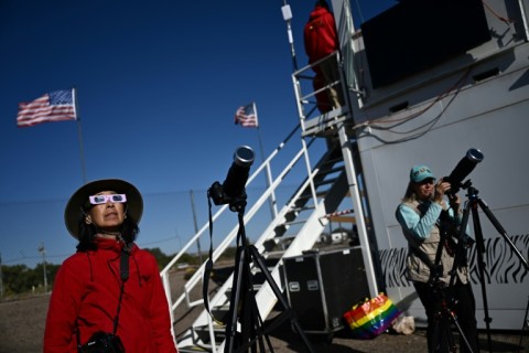 The eclipse will cross a handful of major cities, including Albuquerque, where these skygazers watched as it began