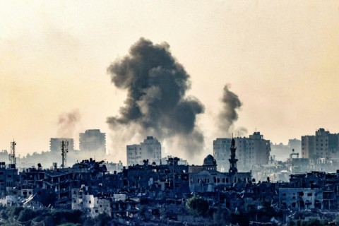 A picture taken from the southern Israeli city of Sderot on October 25, 2023 shows smoke ascending over the northern Gaza Strip following an Israeli strike