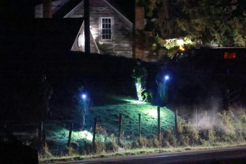 Law enforcement officials search an area at the family home of suspect Robert Card on October 26, 2023 in Bowdoin, Maine