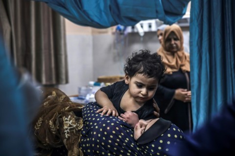 A wounded Palestinian woman and her child are wheeled into the Nasser hospital following Israeli bombardment, in Khan Yunis, in the southern Gaza Strip on October 26, 2023