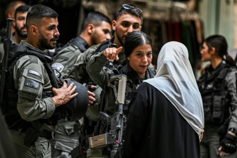 An Israeli border guard argues with a woman as Muslim worshippers are denied entry to the Aqsa mosque compound in the Old City of Jerusalem