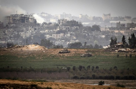 Israeli Merkava tanks take position along the Israeli border with the Gaza Strip on October 29, 2023