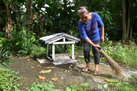 Agatha Ando's husband and three of her siblings died along with four children when water and debris crashed over them