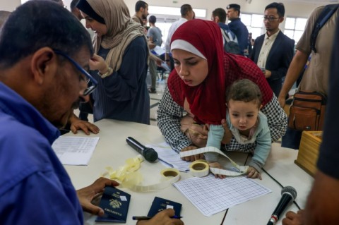 Foreign passport holders have begun to leave Gaza for Egypt after the Rafah border crossing was opened for limited numbers of residents to escape the conflict  