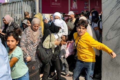 People from Gaza enter the Rafah border crossing to Egypt in the southern Gaza Strip on November 1, 2023