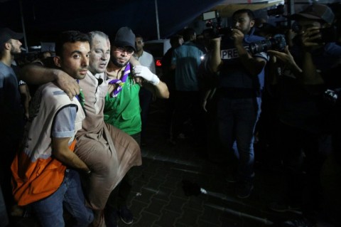 A wounded man is carried to the Al-Shifa hospital in Gaza City late on November 5