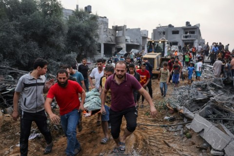 Palestinians transport the body of a air strike victim in southern Gaza