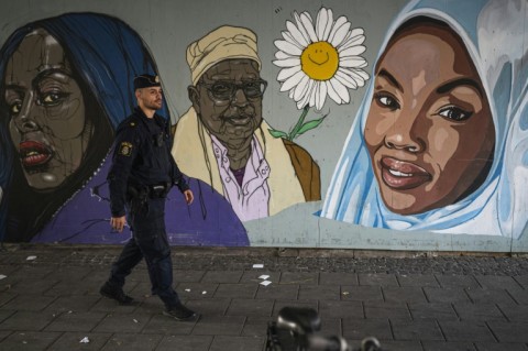 A police officer patrols the troubled Stockholm suburb of Rinkeby