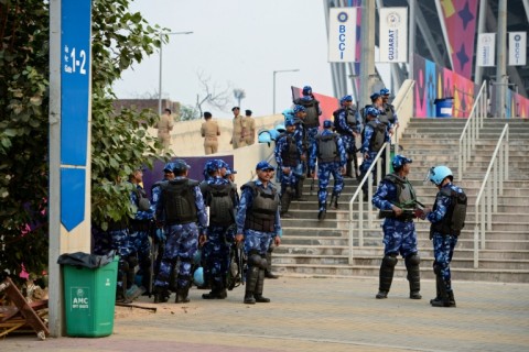 Security personnel gather outside the Narendra Modi Stadium in Ahmedabad on November 18