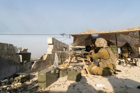 Israeli soldiers man a position in the northern Gaza Strip