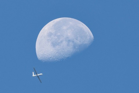 The moon setting as an Israeli drone flies above the Gaza Strip