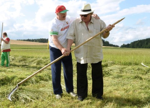 President Alexander Lukashenko teaches Depardieu how to use a scythe on a trip to Belarus in 2015 