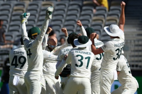 Australia's Nathan Lyon (centre L) celebrates with teammates after taking his 500th Test wicket