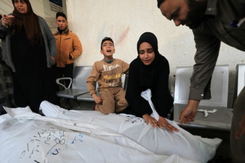 Relatives of a man killed in Israeli bombardment mourn ahead of his funeral, at the Najjar hospital in Rafah, in the southern Gaza Strip on December 21, 2023