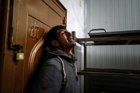 A man mourns a loved one killed during Israeli bombardment, at Nasser Hospital in Khan Yunis on the southern Gaza Strip on December 27, 2023