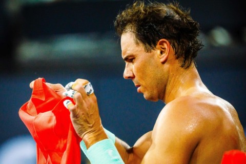 Spain's Rafael Nadal changes his shirt as he takes a break at the Brisbane International