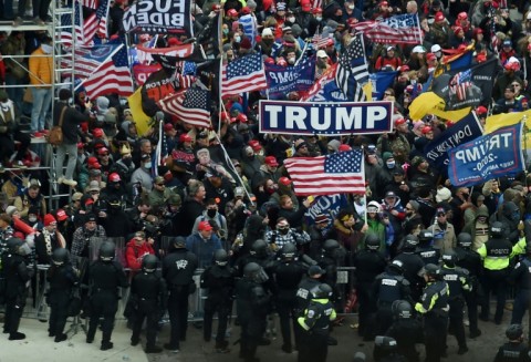 Police hold back supporters of US President Donald Trump as they gather outside the US Capitol's Rotunda on January 6, 2021