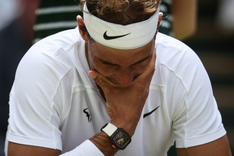 Hurt: Nadal at Wimbledon in 2022 where he had to forfeit his semi-final with an abdominal tear