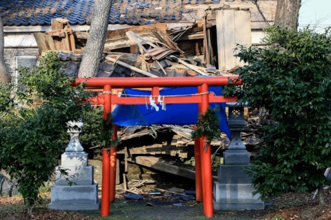 The traditional red gate of one shrine in the city of Wajima remained standing