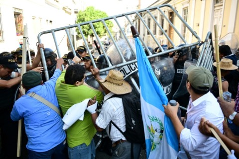 Supporters of Arevalo clash with the police during a demonstration outside the Congress to protest against the earlier suspension of the inauguration of the new legislature