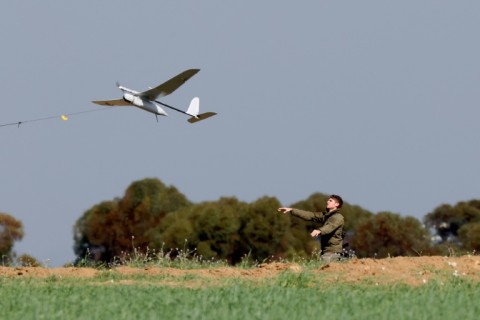 An Israeli soldier launches a drone from southern Israel along the Gaza border