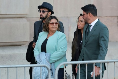 Dani Alves' mother Lucia Alves,  seen here arriving for his trial with the family's lawyer Graziele Queiroz and two of her sons, risks facing prosecution herself after she named and pictured her son's accuser in a social media post 