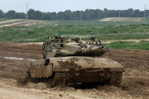 An Israeli tank on the border with the Gaza Strip amid ongoing battles between Israel and the Palestinian militant group Hamas