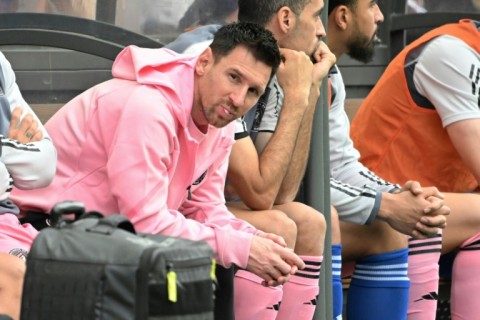 Lionel Messi sits on the bench during the friendly football between a Hong Kong XI and Inter Miami