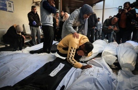 Palestinians mourn over shrouded bodies of relatives killed in overnight Israeli bombardment on the southern Gaza Strip at Al-Najjar hospital in Rafah on February 8, 2024