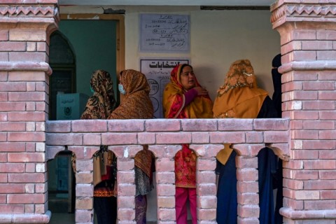 Women waiting to cast their ballot a polling station in Lahore