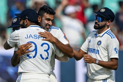 India's Ravichandran Ashwin celebrates after taking his 500th wicket, that of England's Zak Crawley, during the second day of the third cricket Test in Rajkot