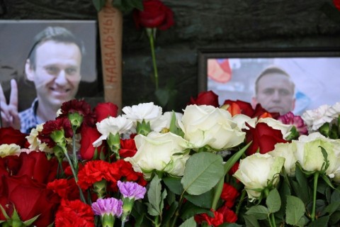 Some impromptu floral tributes were quickly dismantled by groups of people in plain clothes