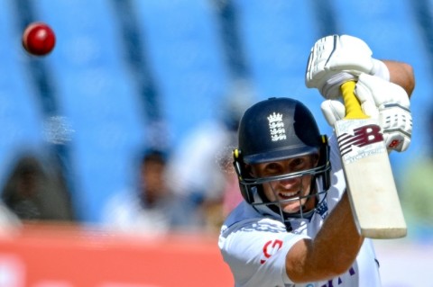 England's Joe Root plays a shot during the fourth day of the third Test cricket match between India and England at the Niranjan Shah Stadium in Rajkot on February 18