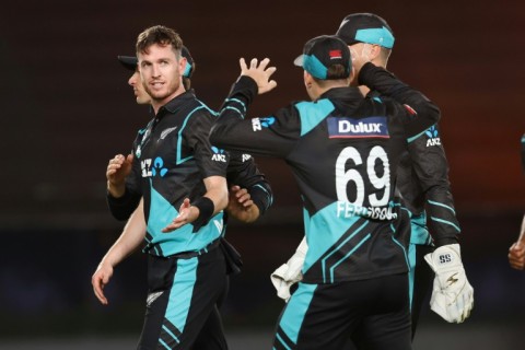 New Zealand’s Adam Milne (L) celebrates the wicket of Australia’s Tim David 